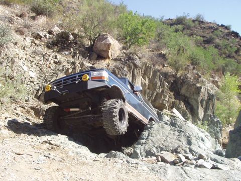 1993 Ford Bronco - This 1993 Ford Bronco is navigating a rocky, off-road trail with steep inclines and large boulders.