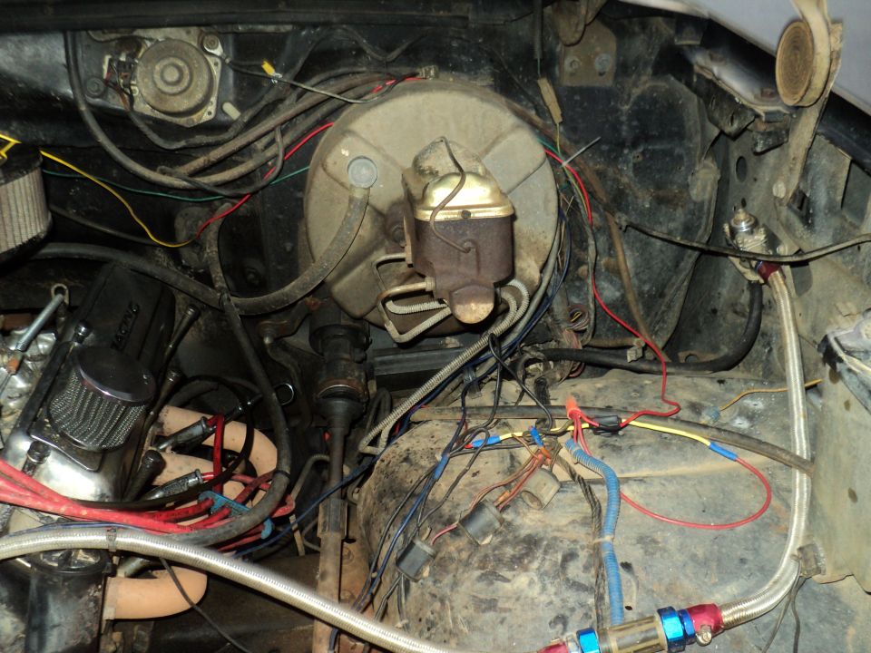 Engine bay showing brake booster, master cylinder, and wiring