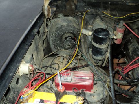 1986 Ford Bronco - Close-up view of an engine bay an MSD ignition box and battery, with various wires and components visible.