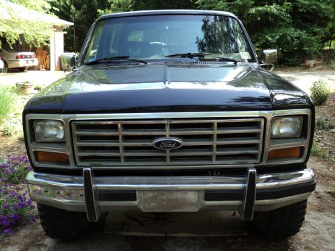 1986 Ford Bronco - Front view of a 1986 Ford Bronco, highlighting its distinctive grille and chrome bumper.