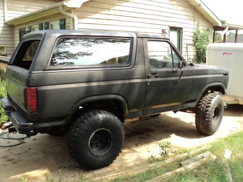 1986 Ford Bronco - This lifted black Ford Bronco appears to be from the early 1980s, not a 1986 model.