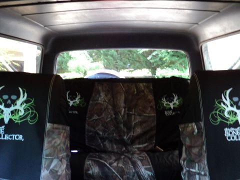 1986 Ford Bronco - Custom seat covers with skull and antler graphics are visible inside the vehicle.