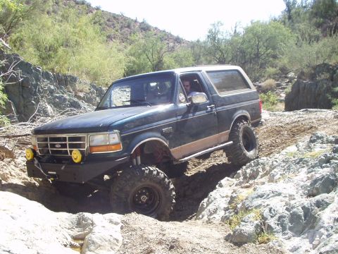 1993 Ford Bronco - Ford Bronco tackling a challenging rocky terrain on an off-road adventure.