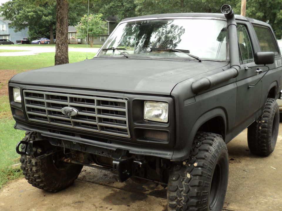 Black Ford Bronco with snorkel, lifted suspension, and off-road tires
