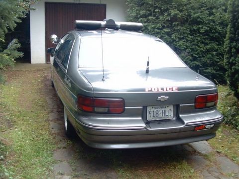 1991 Ford LTD Crown Victoria - This 1991 Ford Crown Victoria police car is seen from the rear, parked in a driveway.
