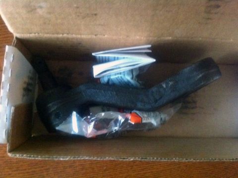 2001 Mercury Grand Marquis - A new car part, possibly a steering component, is shown inside its packaging with accompanying paperwork.