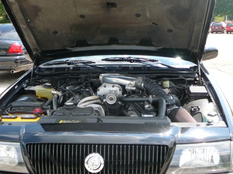 1999 Mercury Grand Marquis - Engine bay of a 1999 Mercury Grand Marquis showing a supercharger and custom air intake.