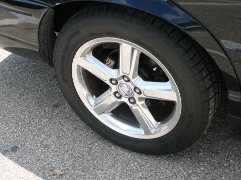 1999 Mercury Grand Marquis - Close-up of a car's wheel, showing the rim and tire detail.