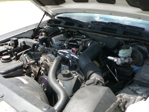 1999 Mercury Grand Marquis - The engine bay of a 1999 Mercury Grand Marquis, showing the V8 engine and associated components.