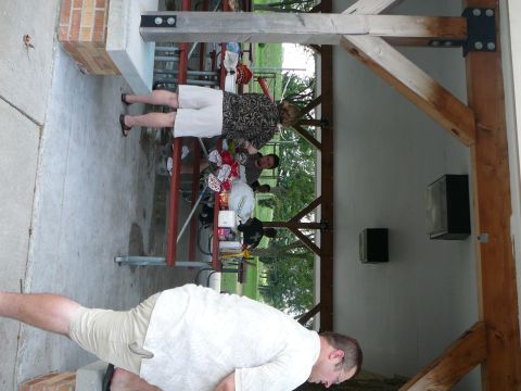 1999 Mercury Grand Marquis - People gather under a covered picnic area with trees and grass visible in the background.