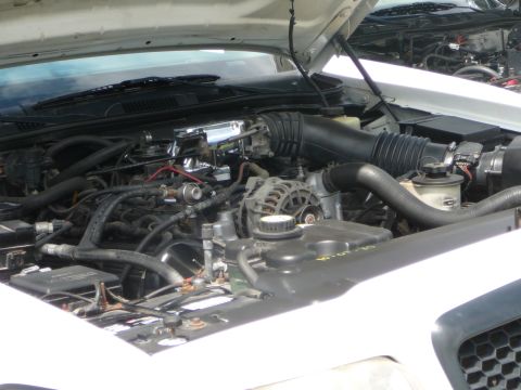 1999 Mercury Grand Marquis - Engine bay of a 1999 Mercury Grand Marquis, showing the V8 engine and associated parts.
