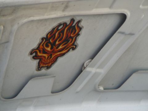 1999 Mercury Grand Marquis - A sticker of a skull engulfed in flames is affixed to the underside of a vehicle's hood.