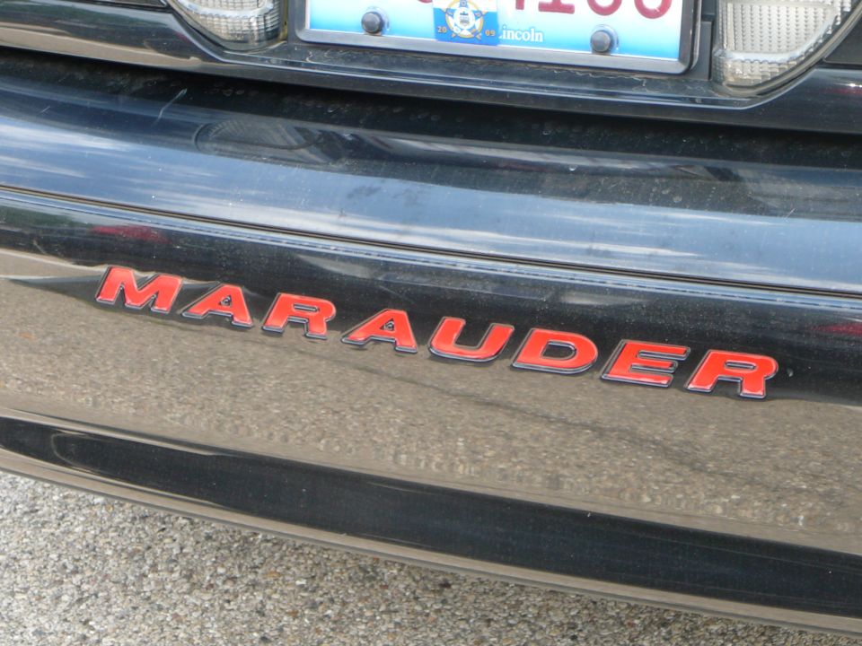 Black car rear bumper with red "Marauder" emblem and a license plate