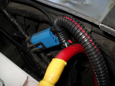 1990 Ford Bronco - Detail of a vehicle's electrical wiring, showing a blue connector and insulated cables.