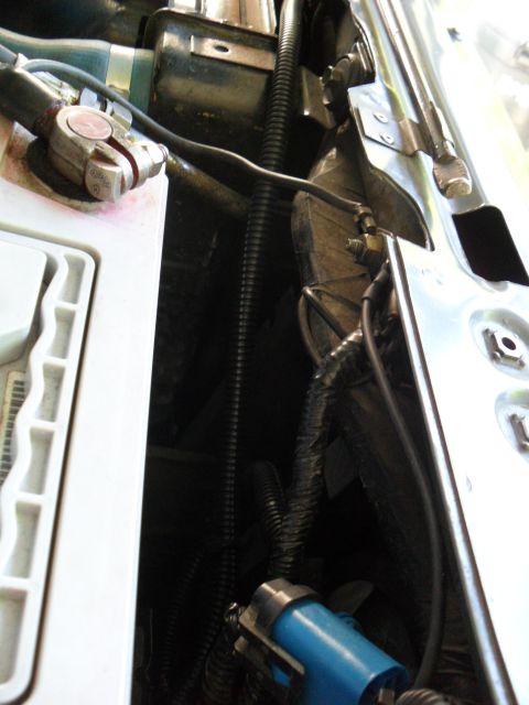 1990 Ford Bronco - Close-up view of engine bay wiring and a battery terminal, with no clear vehicle identification visible.