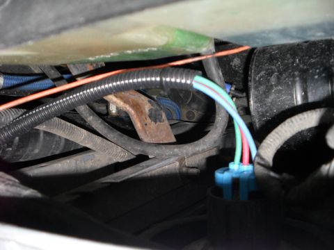 1990 Ford Bronco - The image shows a close-up view of a vehicle's electrical wiring, focusing on a connector and various cables.