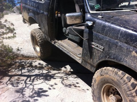 1990 Ford Bronco - This 1990 Ford Bronco is navigating a rocky trail with its door open.