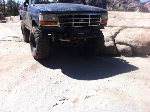 1990 Ford Bronco - This Ford truck is navigating a rocky terrain, its off-road capabilities.