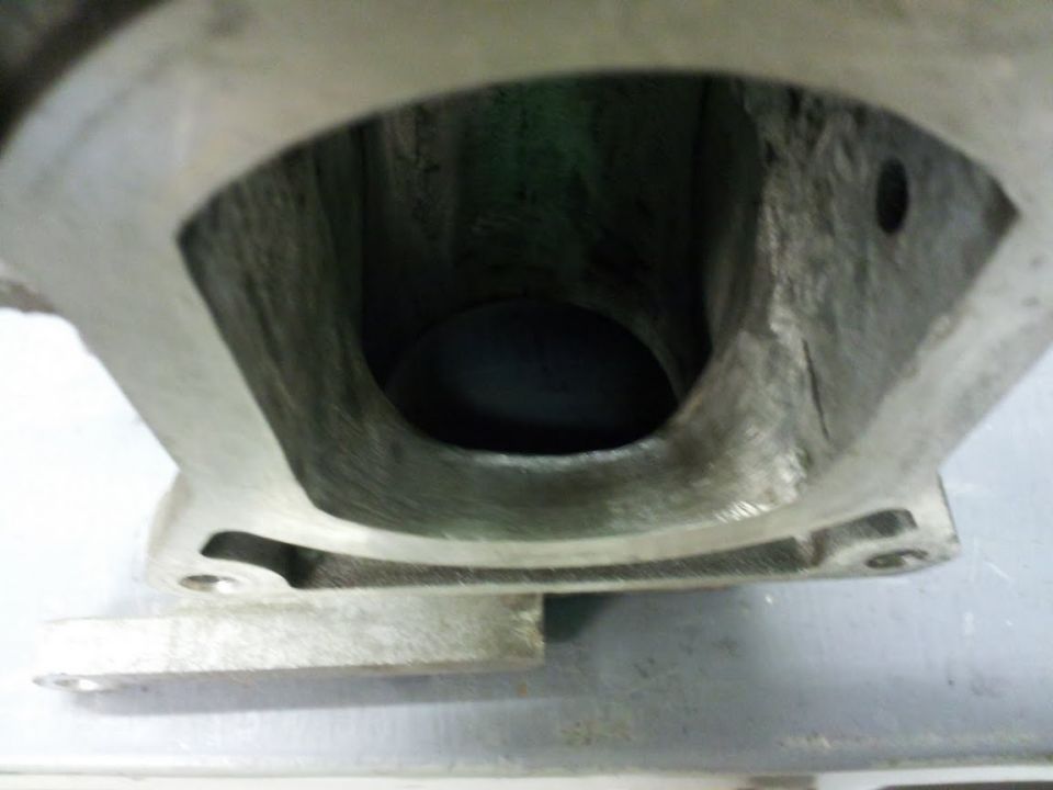 Close-up of an engine intake manifold port, showing internal casting