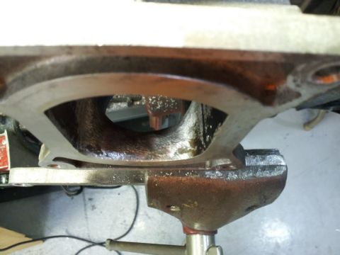 2000 Mercury Grand Marquis - Close-up view of an engine intake manifold being worked on in a vise.