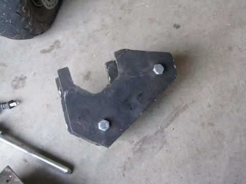 1984 Ford Bronco - A metal bracket, likely a vehicle part, is shown with two bolts. The image includes a Supermotors.net watermark.