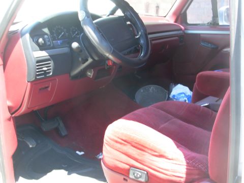 1995 Ford Bronco - The upholstery is in better-than-average condition, but pimp-red.