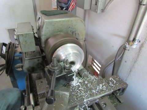 1995 Ford Probe - Metal lathe in operation, producing metal shavings from a workpiece.