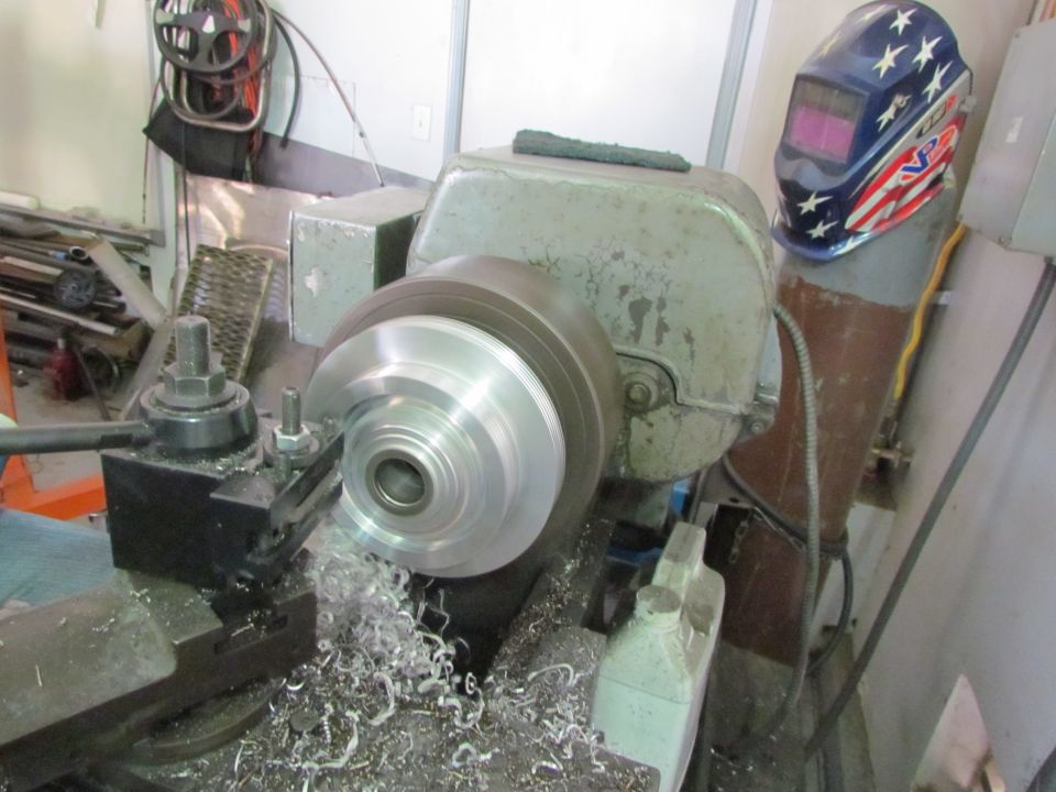 Brake rotor being machined on a brake lathe in a workshop