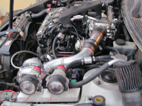 1995 Ford Probe - Engine bay modifications with twin turbochargers and custom piping are visible.
