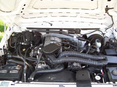 1993 Ford F-150 - Engine bay of a 1993 Ford F-150, its V8 engine and associated components.