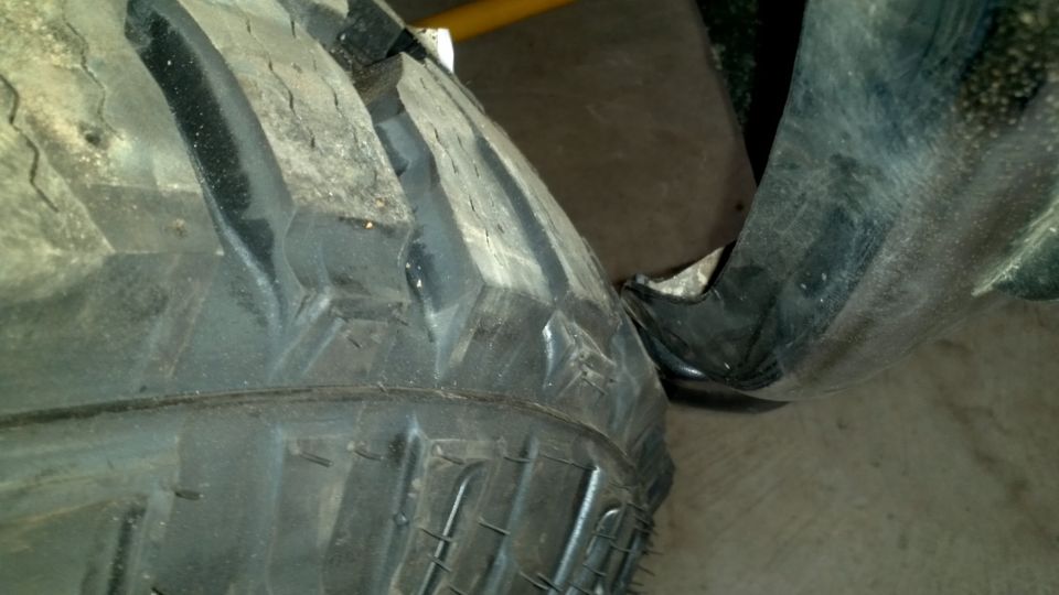 Close-up of a large tire and part of a black fender