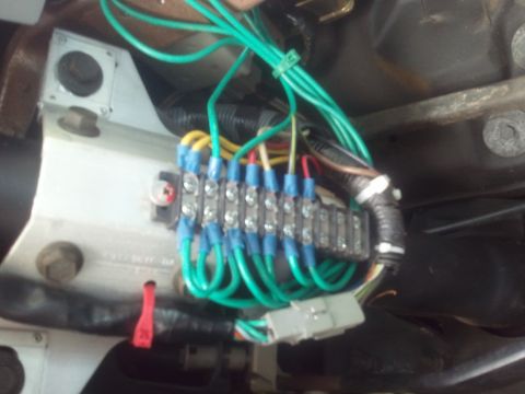 1989 Ford Bronco - A close-up view of a vehicle's electrical system, showing a fuse block and a complex wiring harness.