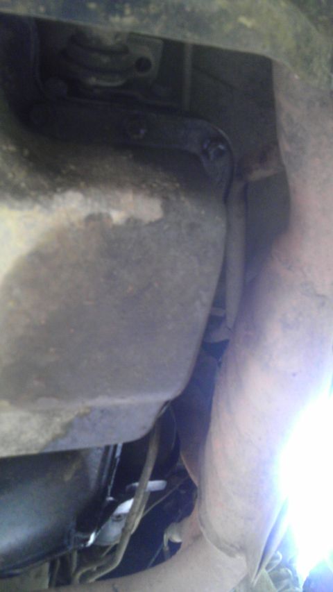 1989 Ford Bronco - Undercarriage view of a vehicle, focusing on the oil pan and exhaust system components.