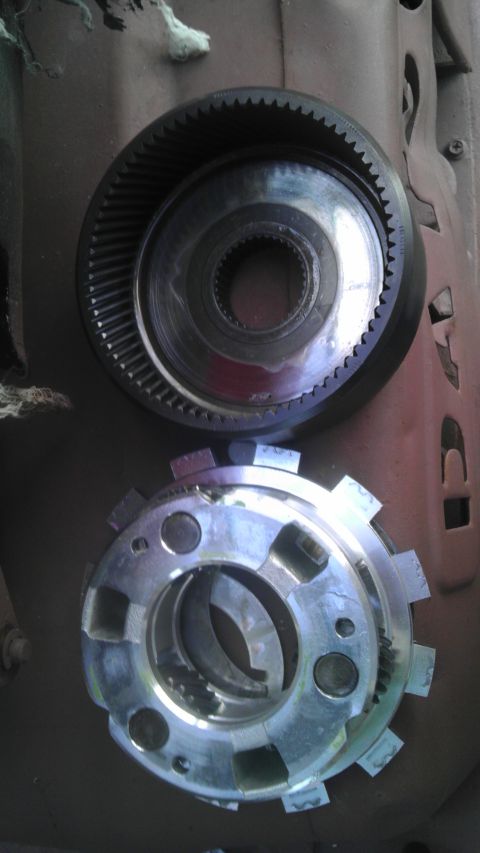 1989 Ford Bronco - Close-up of disassembled transmission parts, showing gears and clutch components.