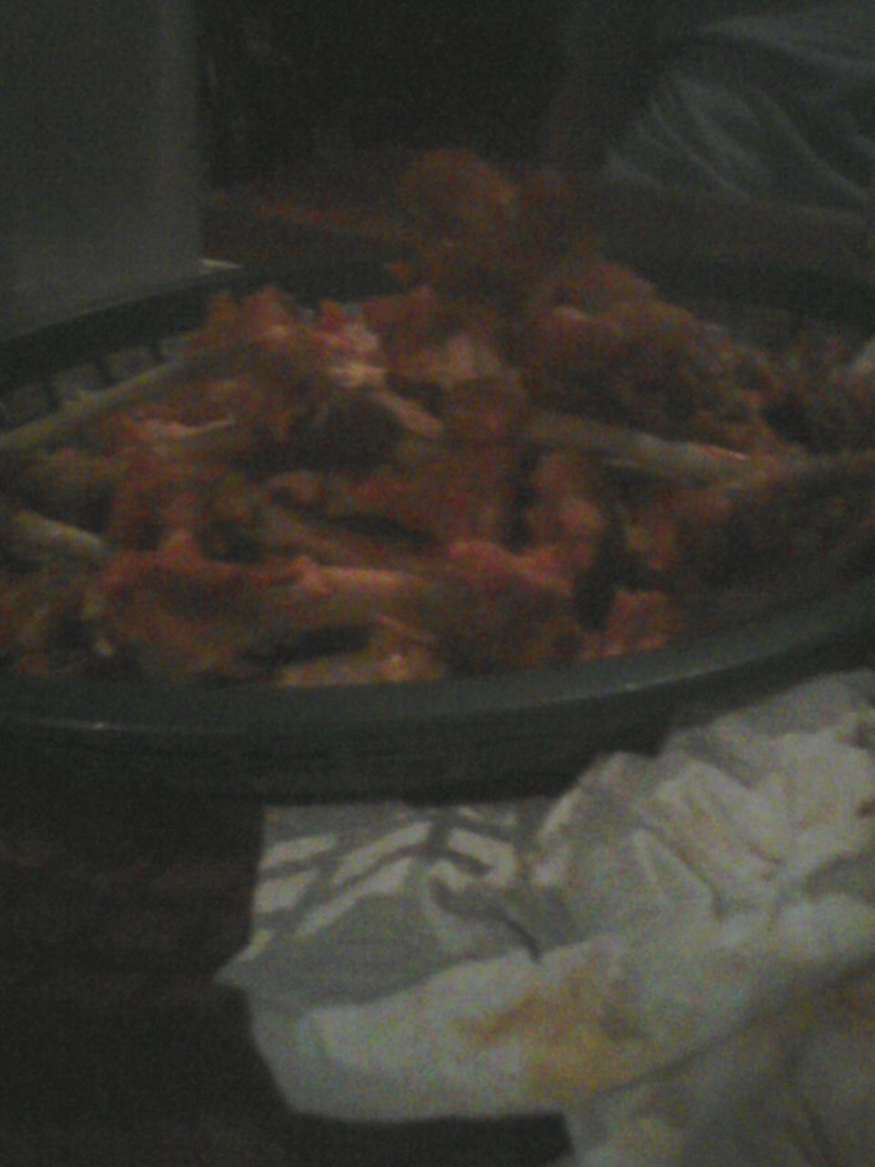 Food in a dark bowl with some green items mixed in