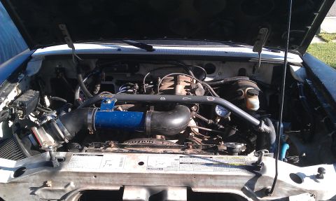1992 Ford Ranger - The engine bay of a 1992 Ford Ranger shows the motor with some aftermarket modifications.