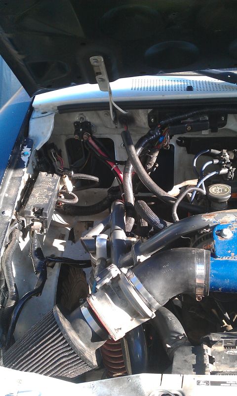 1992 Ford Ranger - The engine bay of a vehicle, an aftermarket air intake system and a blue-painted engine block.