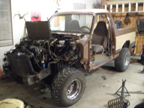 1987 Ford Bronco - This 1987 Ford Bronco is undergoing extensive repairs in a workshop setting.