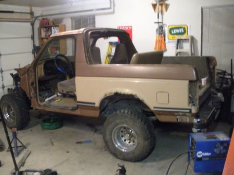 1987 Ford Bronco - This 1987 Ford Bronco is undergoing repairs or modifications in a garage setting.