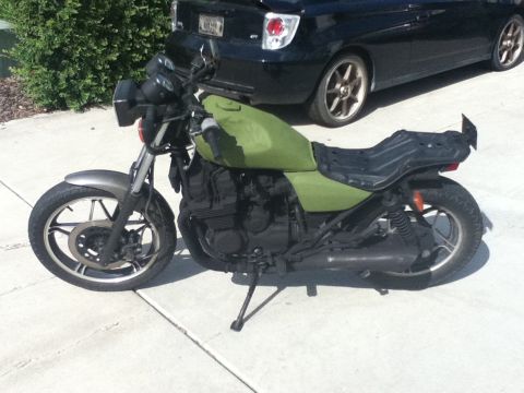 2002 Kawasaki Ninja - A green motorcycle is parked on a concrete surface next to a black car.