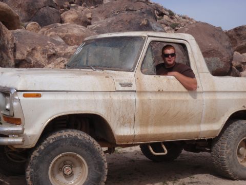 1978 Ford Bronco - A man poses in his white 1978 Ford Bronco, which appears to have been driven off-road.