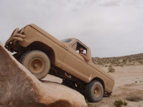 1978 Ford Bronco - 1978 Ford Bronco navigating a rocky obstacle during an off-road excursion.