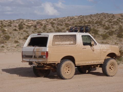 1978 Ford Bronco - This SUV is covered in mud, suggesting it has been off-roading in a desert environment.