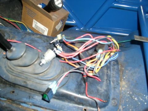 1979 Ford Bronco - Close-up of a vehicle's interior wiring and components, with a box and flashlight in the background.