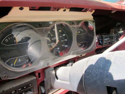 1991 Ford LTD Crown Victoria - Interior view of dusty dashboard gauges including speedometer, fuel, temperature, and oil level indicators.