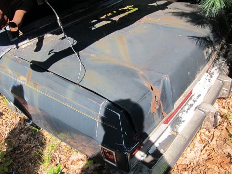 1991 Ford LTD Crown Victoria - Rear view of a 1991 Ford Crown Victoria LTD with significant rust on the trunk and bumper.