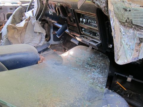 1991 Ford LTD Crown Victoria - Interior view of a heavily damaged vehicle with debris scattered throughout the cabin.