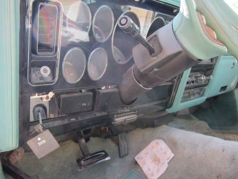 1991 Ford LTD Crown Victoria - The interior of a vehicle shows the dashboard, steering column, and pedals, with some readable text on a key tag.