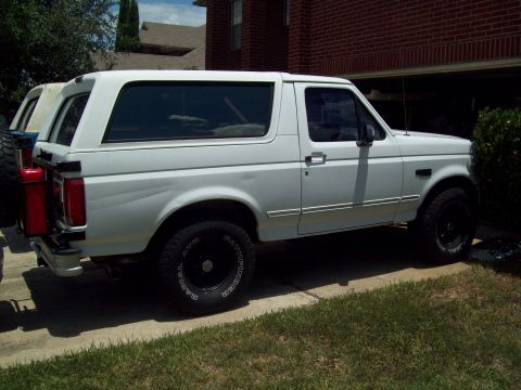 1996 Ford Bronco - the 96 with 33's that came on the 85, homemade 2-jerry can spare tire mount (85 hiding behind)