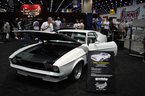 2007 Ford Mustang - A white 1971 Ford Mustang Mach 1 is displayed with its hood open at an indoor event.